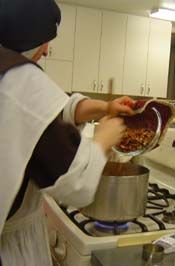 Pouring the pecans in the brittle over the hot flame Pouring the pecans in the brittle over the hot flame
